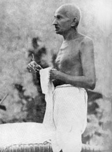 Gandhi cleaning his spectacles, Wardha, 1939
